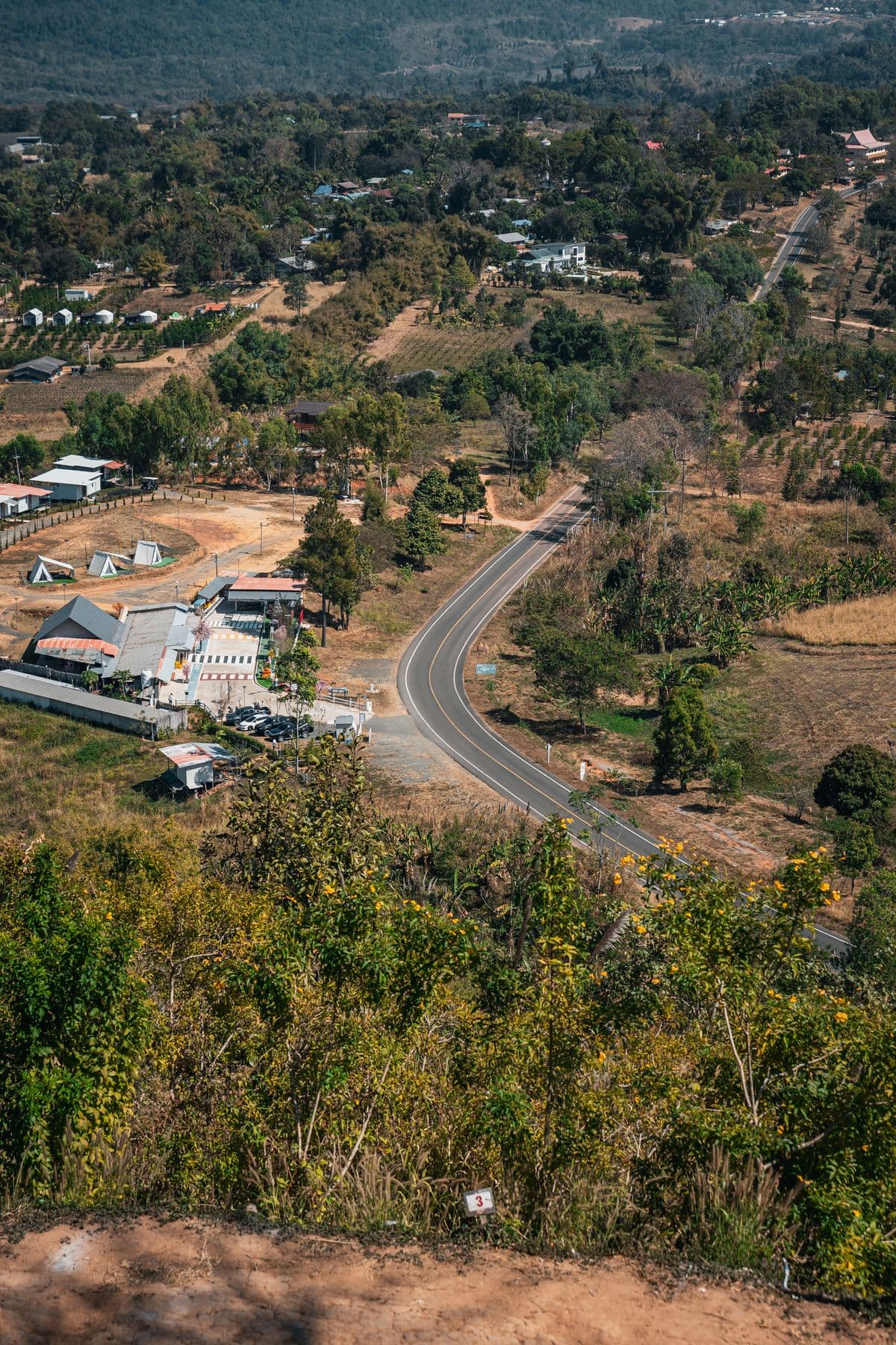 Winding road through a green rural landscape in Thailand